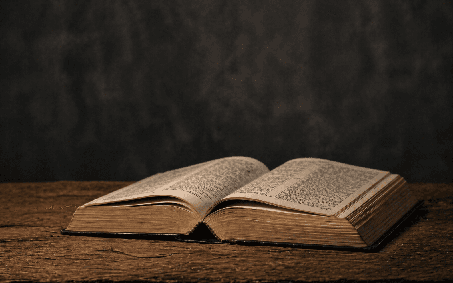 An open Bible on a wooden table